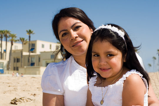 Latino Mother And Daughter On The Beach