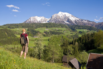 young female on a meadow in the mountainous landscape