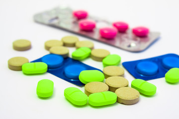 multi coloured pills on white background
