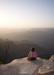 Woman meditating at sunset