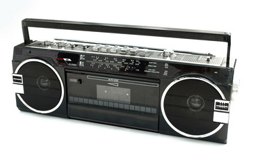 Dirty old 1980s style cassette player radio against a white back
