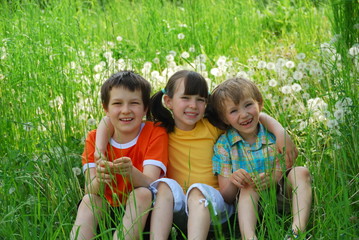 Fototapeta premium Children Sitting in Meadow