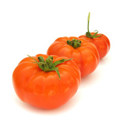Three perfect tomatoes isolated on white background
