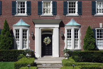 Fototapeta na wymiar elegant house entrance with black shutters
