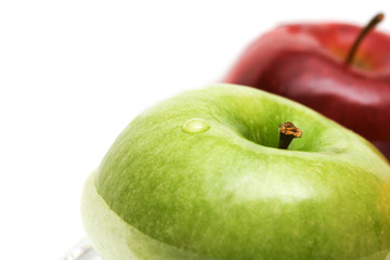 Green and red apples in water