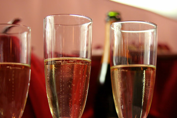 champagne glasses with bottle on background