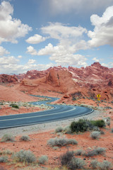 curvy road leading into red rocks