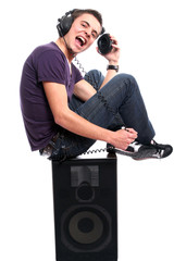 Young man with headphones, seating in a speaker