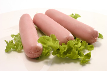 raw sausages on white dish