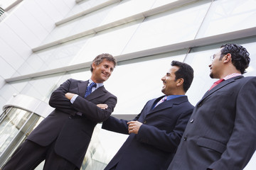 Group of businessmen outside office building