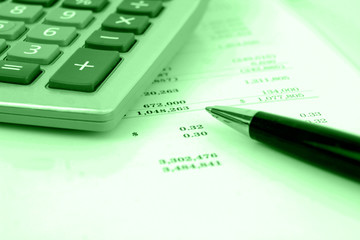 calculator on financial statement with green overlay
