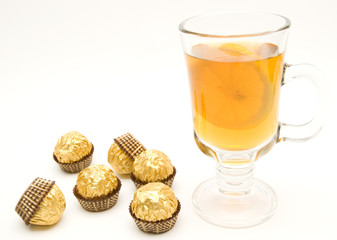 tea with a lemon and candies