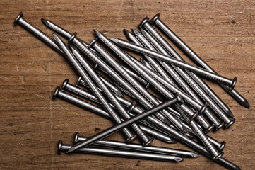 Nails on wooden table.