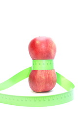 red apples wrapped in a measuring tape