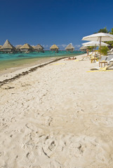 Sandy tropical beach with bungalow, Moorea, French Polynesia