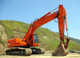 The Big caterpillar excavator of the orange colour 