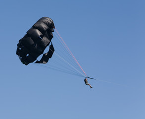 Man Parasailing with Black Parachute