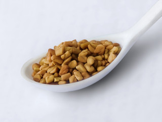 Fenugreek on white spoon