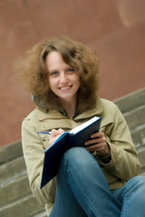 Smiling student with copy-book.