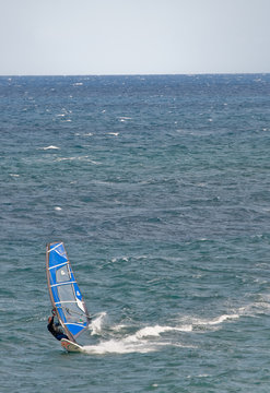 Windsurfer sufing on the sea of beach Pozo Izquierdo. Gran Canar