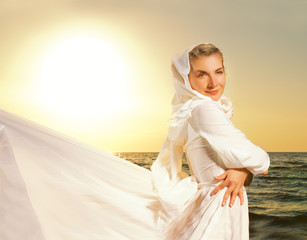 Fototapeta na wymiar Beautiful young woman relaxin on the beach at sunset