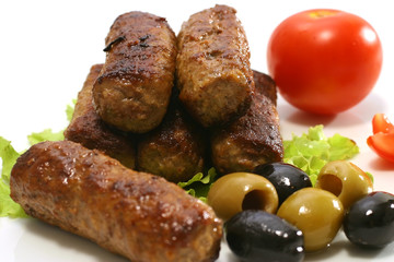 kebab rolls and vegetables on dish