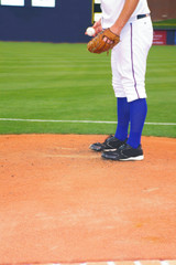 Baseball pitcher on the mound, starting throwing motion