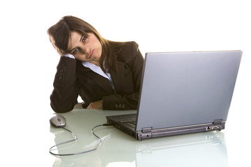 businesswoman with tired expression working with laptop computer