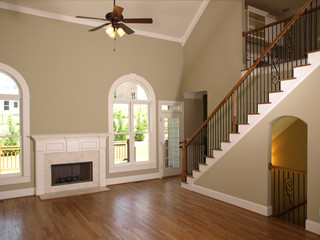 Luxury Model Home Living Room fireplace and staircase