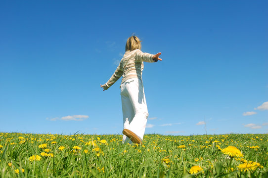 Woman having fun on spring meadow