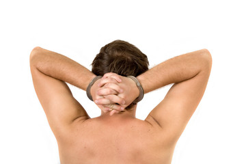 Obraz premium The guy chained in handcuffs. Rear View. Isolated