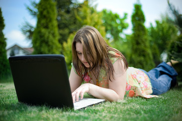 Girl work on laptop in garden