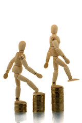 Manikins falling off coin piles