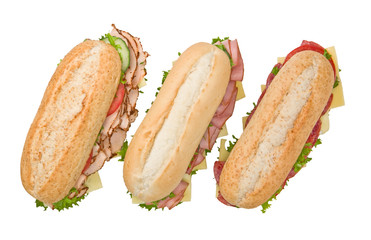 Turkey sandwich, salami sandwich and ham sandwich on white