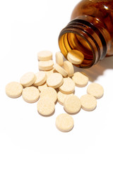 Vitamin C tablets spilling from bottle