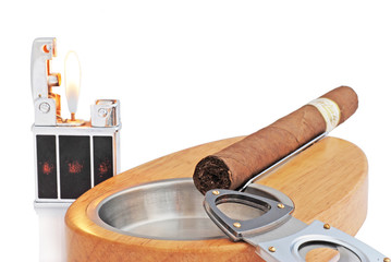 close up of ashtray, lighter and cuban cigar