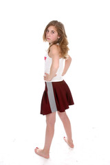 Defiant looking young girl with her hands on her hips.