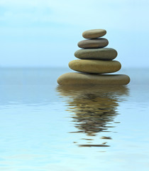 Pebble stack reflecting in the water