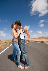 man and woman on the road kissing