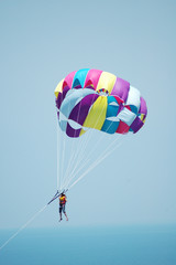 Multi coloured parachute over the blue sky