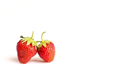 Two strawberries on white background, lots of copy space