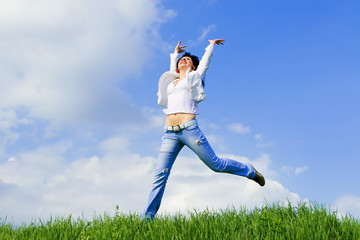 Fototapeta na wymiar happy young woman is jumping