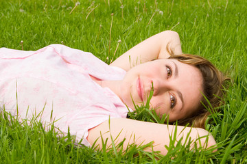 pretty woman rest on the green grass