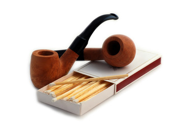 pipes with closeup of white tipped wooden match stickst