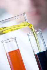 chemical laboratory scene - carefully filling test tube