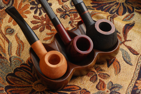 three old hand carved tobacco pipes