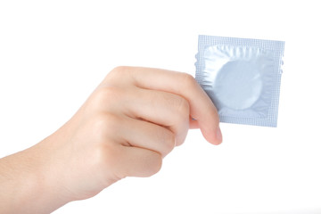 Hand holding a condom isolated on white background.