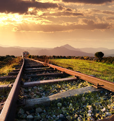 Fototapeta premium landscape for a old railway abandoned at the sunset