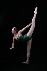 Ballet dancer balancing on one leg with the other pointed up