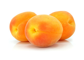 three fresh apricot fruits  isolated